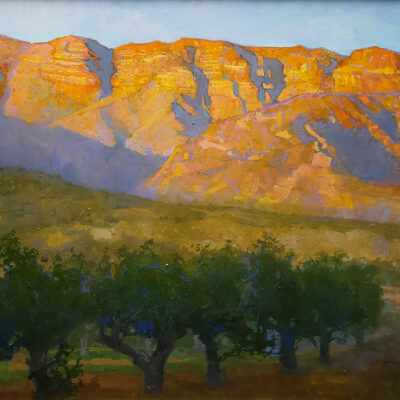 American Legacy Fine Arts presents "The Pink Moment on the Topa Topa Bluffs overlooking an Apricot Orchard; Ojai Valley" a painting by Peter Adams.